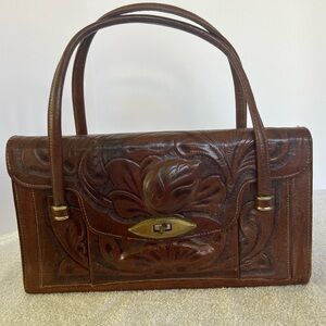 Vintage 1950's hand crafted leather handbag
Hand tooled embossed with roses